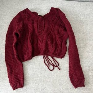 Red cableknit cropped sweater with tie back